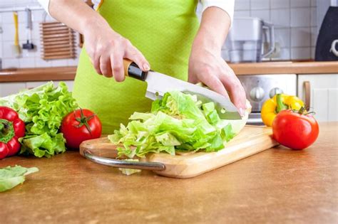 Premium Photo Womans Hands Cutting Lettuce Behind Fresh Vegetables