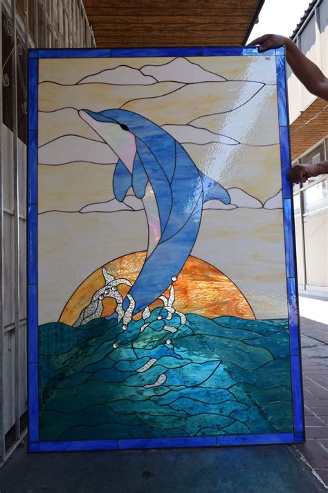 A Stained Glass Window With A Dolphin On It