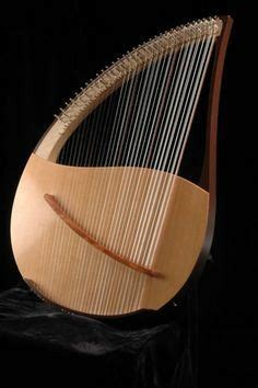 A Large Wooden Harp Sitting On Top Of A Black Table