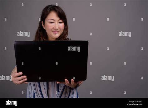 Mature Beautiful Asian Businesswoman Using Laptop Computer Stock Photo