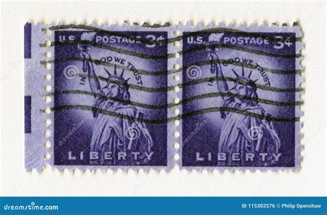 A Pair Of Old Purple Vintage American Postage Stamps With The Statue Of