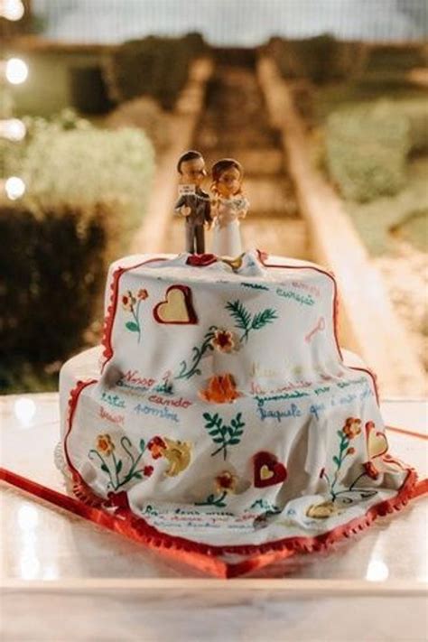 A Wedding Cake With Two Figurines On Top