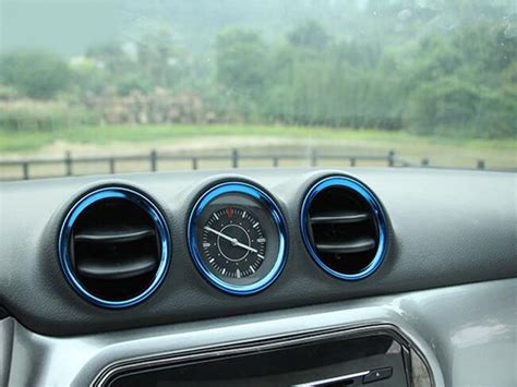 The Dashboard Of A Car With An Analog Clock On It S Center Console In