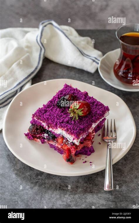 Fruit cake slice. Forest fruit cake on a dark background. Bakery products. Vertical view. Close ...