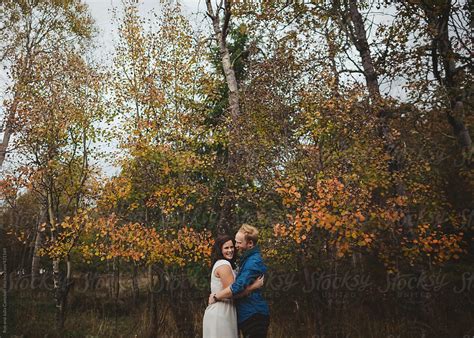 Young Couple Hugging Or Cuddling Outside With Fall Colours And Leaves