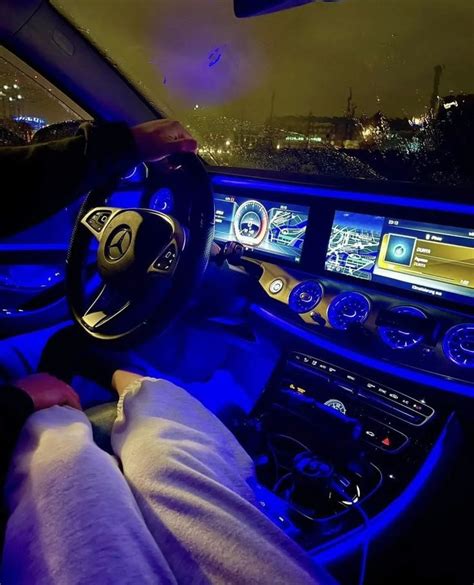 The Interior Of A Car Is Lit Up With Blue Lights And Steering Wheel As