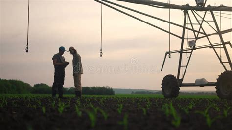 Irrigation Agriculture Two Silhouette Farmers Working In The Field