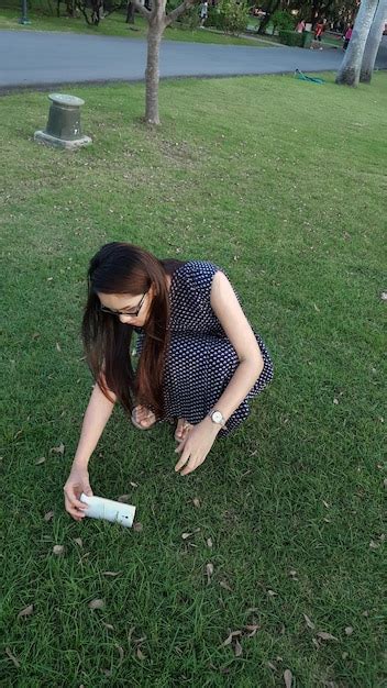 Premium Photo High Angle View Of Woman Crouching On Grass