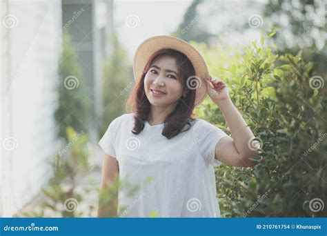 Beautiful Asian Woman Wearing Straw Hat With Smiling Face Standing In