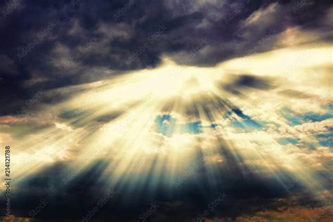 Rays of sunlight coming through dramatic clouds. Stock Photo | Adobe Stock