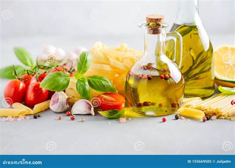 Italian Food Ingredients Pasta Tomatoes Basil And Olive Oil On Gray