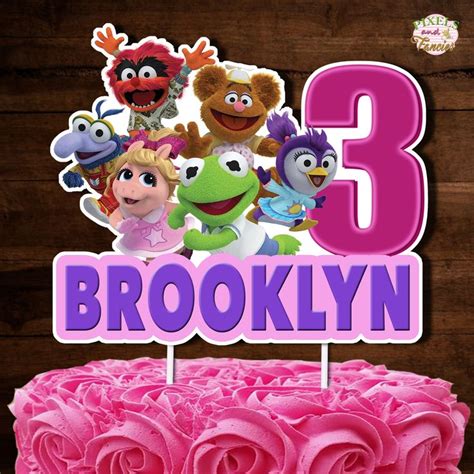 a birthday cake with pink frosting and sesame street characters on the ...