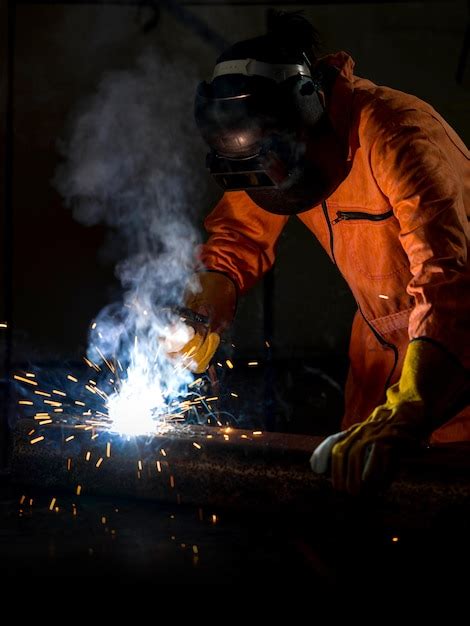 Premium Photo Man Welding In Workshop