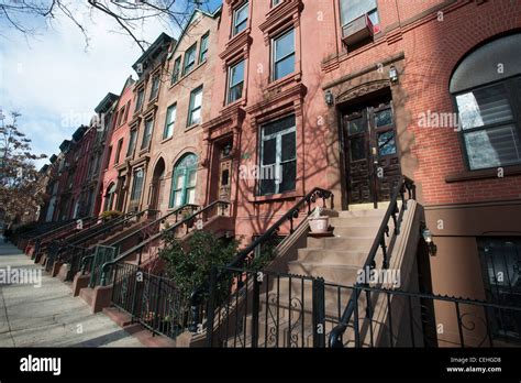 A Group Of Brownstones On A Block In The Harlem Neighborhood Of New