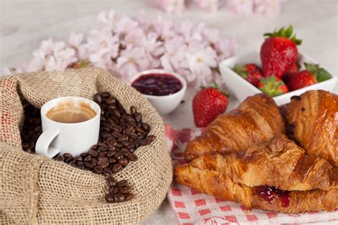 Coffee In Cup With Coffee Beans On Table With Strawberries And