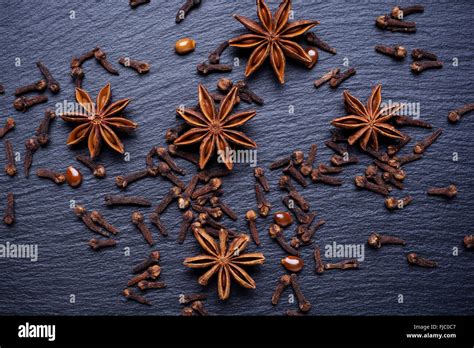 Vintage Photo Star Of Anise And Cloves Lying On Dark Table Seasoning