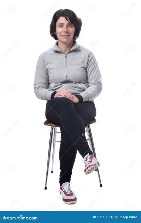 Portrait Of A Woman Sitting On A Chair In White Background Legs Crossed