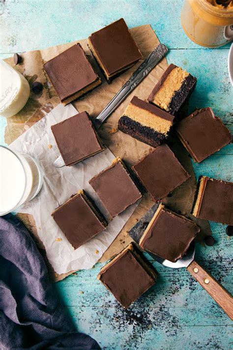 Several Pieces Of Chocolate Cake Sitting On Top Of A Table Next To Cups