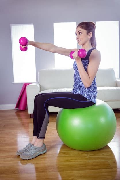 Premium Photo Fit Woman Lifting Dumbbells On Exercise Ball