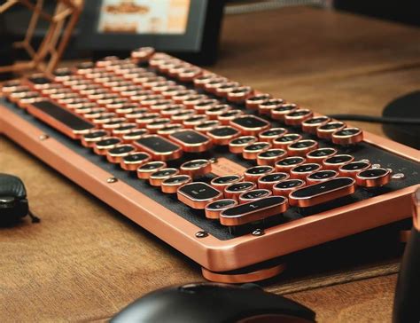 A Computer Keyboard Sitting On Top Of A Wooden Desk