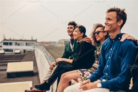 Friends Sitting Together On Rooftop High Quality People Images