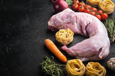 Whole Rabbit Raw Meat With Spices And Vegetables For Tagliatelle Stewing On Black Stone