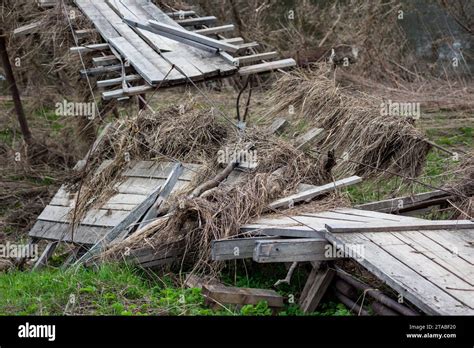 A Broken Pedestrian Suspension Bridge In The Countryside After A Spring