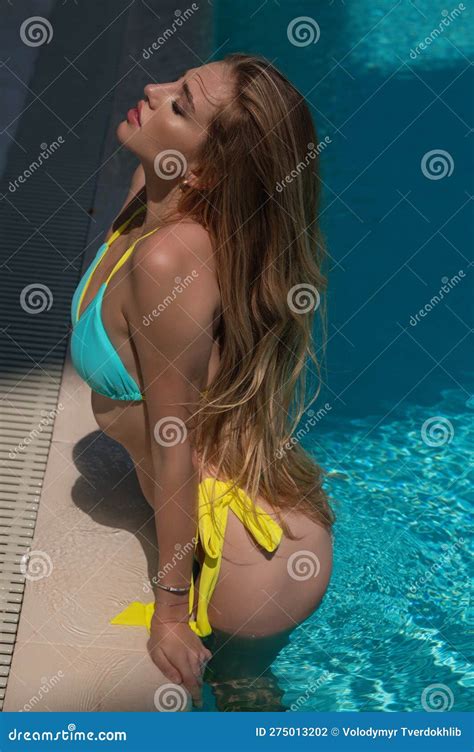 Outdoor Photo Of Beautiful Woman Wears Luxurious Bikini Swimsuit Posing In The Swimming Pool
