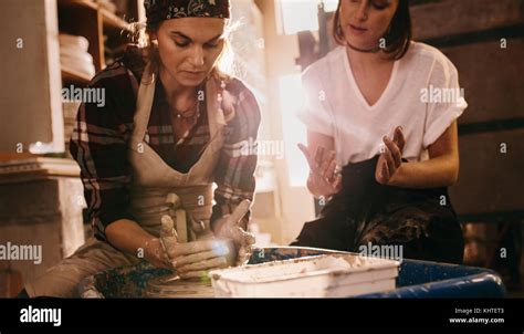 Woman Potter Teaching The Art Of Pot Making Two Women At A Pottery