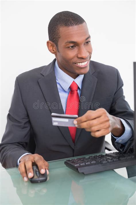 Smiling Young Afro Businessman Doing Online Shopping Stock Photo