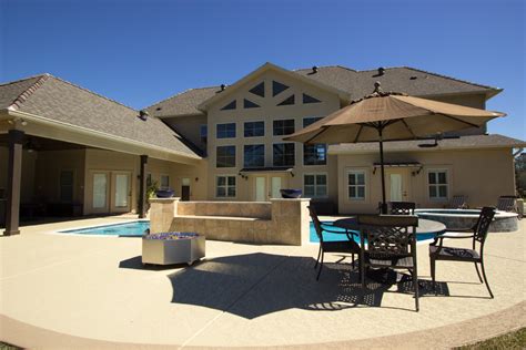 Freeform Swimming Pool With Travertine And Feature Wall Mediterranean