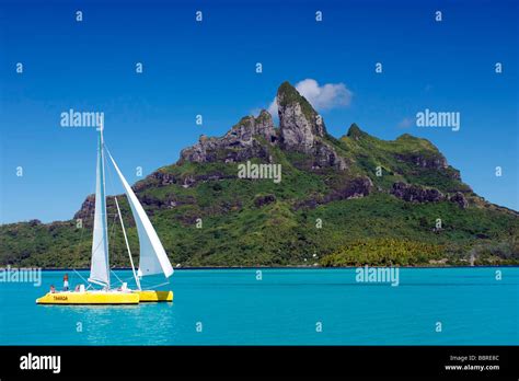 Sailboat Passing In Front Of Otemanu Mountain Island Of Bora Bora