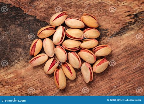 Tabletop View Turkish Red Roasted Pistachios On Wooden Board Stock