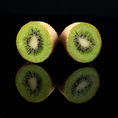 Premium Photo Kiwifruit On Black Reflective Background