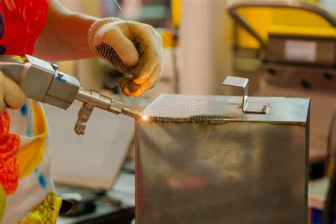 Close Up Welder Hands Using Handheld Laser Welding Machine Stock Image