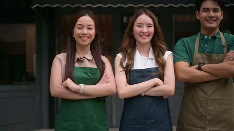 Portrait Group Of Asian Cafe Owners Entrepreneurs Smiling In Coffee