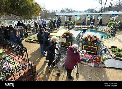 Visitors To Graceland Look At The Gravesite Of Lisa Marie Presley And Her Son Benjamin Keough As