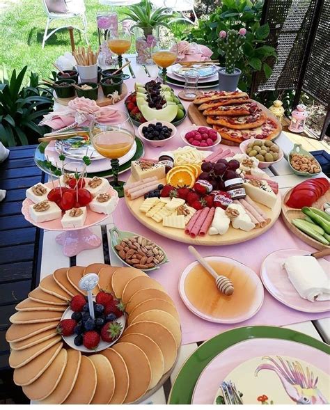 A Table Full Of Different Types Of Food And Drinks On It S Tables Outside