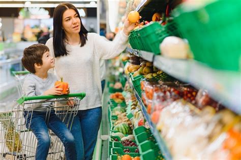 Premium Photo Mother And Her Son Buying Fruits At A Farmers Market