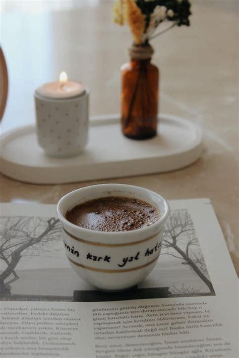 Cup of Coffee on Journal · Free Stock Photo