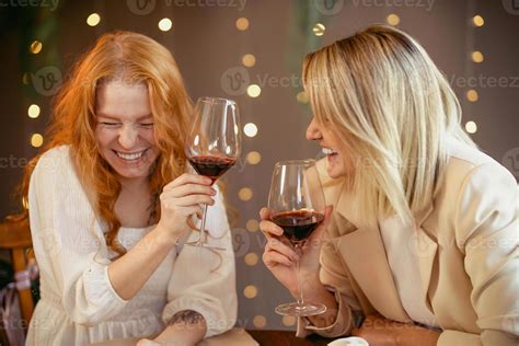 Lesbian Couple Having Dinner In A Restaurant Girls Drink Wine And Talk