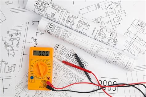 Premium Photo | Digital multimeter and paper electrical engineering drawings