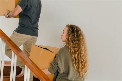 Cheerful Diverse Couple Unboxing Stuff In Bedroom Of New House · Free