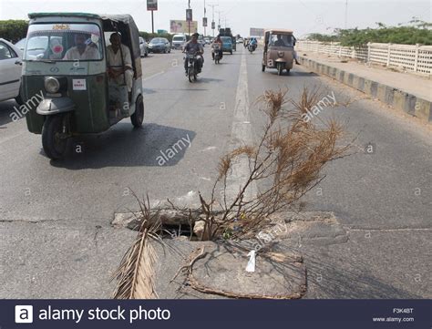 Commuters Passing Through Nearby The Hole On Bridge Near Natha Khan