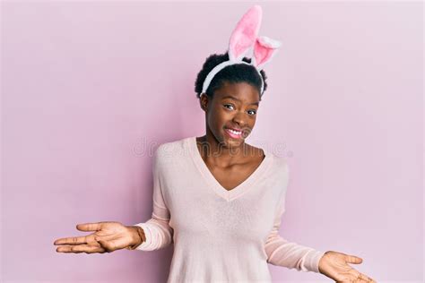 Young African American Girl Wearing Cute Easter Bunny Ears Clueless And