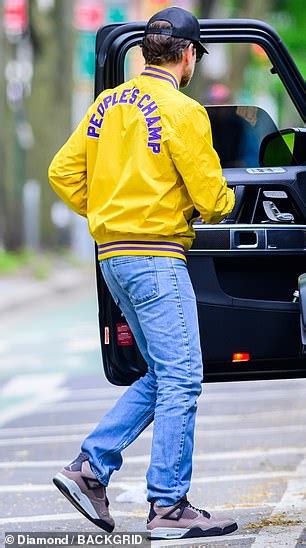 Bradley Cooper Wears A Bright Yellow Bomber Jacket That Says Muhammad Ali 1974 On The Front And