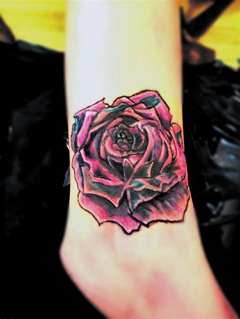 Colorful rainbow rose cover up on the ankle done by tattoo artist Scooby aka Scott at Southern ...