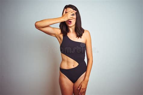 Beautiful Woman Wearing Bikini Swimwear Over White Isolated Background Peeking In Shock Covering