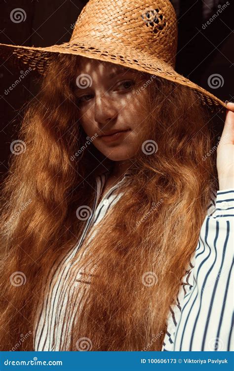 Lovely Young Red Haired Model With Long Wavy Hair In Straw Hat Stock