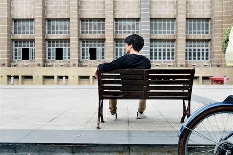 Premium Photo Guy Sitting On A Bench Alone